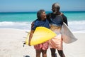 Old couple with surfboard at the beach Royalty Free Stock Photo