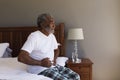 Senior man suffering from stomach ache in bedroom Royalty Free Stock Photo