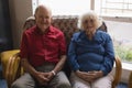 Front view of senior couple with hand clasped looking at camera in nursing home Royalty Free Stock Photo