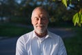 Front view of senior man standing outside in spring nature. Royalty Free Stock Photo