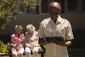 Front view of senior man suing digital tablet in garden