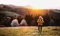 Front view of senior woman hiker walking outdoors in nature at sunset. Royalty Free Stock Photo