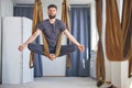 Man meditating in an aerial yoga hammock Royalty Free Stock Photo