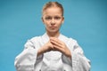 Serious little fighter in kimono looking at camera