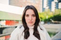 Front view of serious young woman looking at camera. Close up portrait of brunette teenage girl standing outdoors. Photo Royalty Free Stock Photo