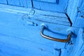 Front view of shiny steel metal old rusty door handle, blue keyhole Royalty Free Stock Photo