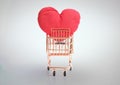 Front view of shopping cart with big red heart and clipping path on grey background Royalty Free Stock Photo