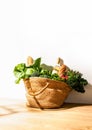 Front view of shopping straw bag full of fresh leafy vegetables. Healthy food ingredients shopping concept Royalty Free Stock Photo