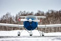 Front view of the shrouded small sports airplane at the winter airfield Royalty Free Stock Photo