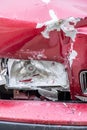 front view of the side of a red car dented by traffic impact Royalty Free Stock Photo