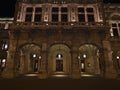 Front view of the side entrance of Vienna State Opera house in the historic center of Vienna, Austria at night with lanterns. Royalty Free Stock Photo