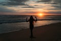 Front view silhouette of attractive woman. Beautiful young girl with long hair walking on the beach, posing at sunset Royalty Free Stock Photo