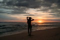 Front view silhouette of attractive woman. Beautiful young girl with long hair walking on the beach, posing at sunset Royalty Free Stock Photo