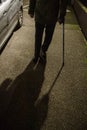 Front view of silhouette of senior man walking on French street at night using