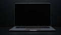 Front view of a silver laptop with a black blank screen on a dark surface Royalty Free Stock Photo