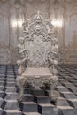 Front view of single ancient sculptures of stone chair in antique decorated room