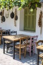 Front view of small cafe exterior. Table and empty chairs outdoor near the white wall. Tourist places. Typical Mediterranean Royalty Free Stock Photo