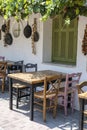 Front view of small cafe exterior. Table and empty chairs outdoor near the white wall. Tourist places. Typical Mediterranean Royalty Free Stock Photo