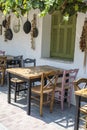 Front view of small cafe exterior. Table and empty chairs outdoor near the white wall. Tourist places. Typical Mediterranean Royalty Free Stock Photo