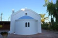 Front view on a small church with a tiny belfry in a tourist resort in Greece. Royalty Free Stock Photo