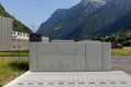 Front view of a small concrete wall in the Swiss countryside.