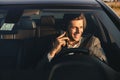 Front view of smiling bussinesman in suit driving his car Royalty Free Stock Photo