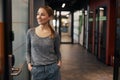 Happy female office worker daydreaming in the corridor