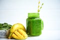 Front view of smoothie with banana, mango, spinach on wooden table. Healthy food. Vegetarian diet Royalty Free Stock Photo