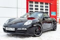 Front view of the 2006 sports porsche boxster s coupe roadster prepared for sale with a polished shiny black body on snow winter