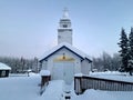 Front View of St Nicholas Russian Orthodox Church in Eklutna, Alaska on a Clear Winter Day, White Wooden Church Royalty Free Stock Photo