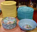 Front view of stacks of colorful decorative modern plates at a store for home decoration