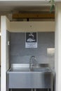 Front view of a stainless steel sink for cleaning fish in a campsite