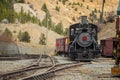 Front view of steam locomotive of Georgetown loop railroad in Colorado, USA. Engine is parked in a depot, looking from the low