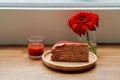 Front view Strawberry layer cake on wooden plate and strawberry jam in glass cup and red flower on glass vase,on wooden floor Royalty Free Stock Photo