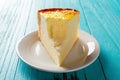 Front view studio shoot of home made cheese cake on blue table with a bite Royalty Free Stock Photo