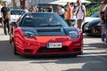 mid-engine V6 Honda NSX. It is red with black carbon fiber