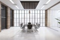 Front view on stylish sunny spacious meeting room interior with black conference table and chairs in the center, big lattice