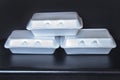 Front view of Styrofoam takeaway boxes, white foam boxes, rectangular shaped clamshell style container with an attached lid, on Royalty Free Stock Photo