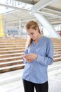 Front view successful caucasian businesswoman in black suite who standing in downtown, he using cell phone with city background Royalty Free Stock Photo