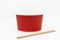 Front view a takeaway noodle bowl container with wooden chopsticks, empty takeaway red food container on white background, blank Royalty Free Stock Photo