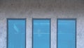 Part of three blue glass windows on loft cement wall in house building site Royalty Free Stock Photo