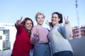 Front view of three Teenage girls making a peace sign outdoors in a sunny day Royalty Free Stock Photo