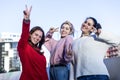 Front view of three Teenage girls making a peace sign outdoors in a sunny day Royalty Free Stock Photo