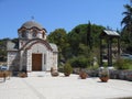 Front view to white and brown church of Agios Nikolaos and Agia Anastasia at the fishing harbour of Olympiada, Halkidiki and belfr