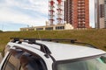 Front view of the top of a white metal crossover body on a roof on a summer day against a background of a residential building and Royalty Free Stock Photo