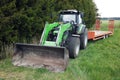 Front view of tractor with front end loader and trailer Royalty Free Stock Photo