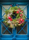 A Christmas wreath hung on a half-glazed house door Royalty Free Stock Photo