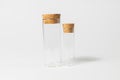 Front view of transparent empty glass jar or test tube bottles with closed brown cork cap lids on white background Royalty Free Stock Photo