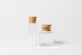 Front view of transparent empty glass jar or test tube bottles with closed brown cork cap lids on white background Royalty Free Stock Photo