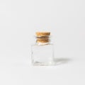 Front view of transparent empty glass jar bottle with closed brown cork cap lids on white background Royalty Free Stock Photo